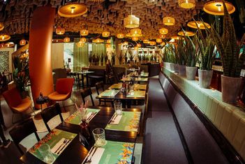 Interior of a stylish restaurant with tables and plants. slide-15
