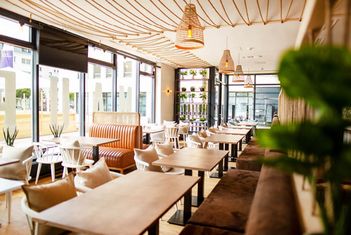 Bright and modern café interior with wooden tables slide-4